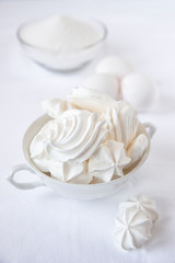 Meringues.  Protein sugar cake for tea or coffee. Light background.White on white.