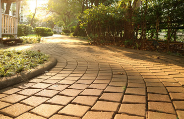 Garden's curving stone block pathway in the gentle sunlight