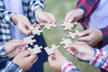 Many persons holding pieces of jigsaw puzzle,Teamwork concept,,Business connection,Success and strategy concept,Business accounting
