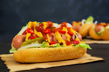 Delicious homemade hot dog on dark background