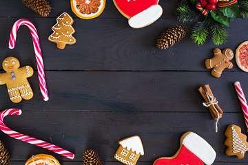 Christmas sweets, ginger cookies on wooden background. Christmas background