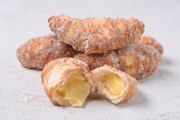 group of sugary croissants on white textured background