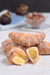 sugary stuffed croissants broken on white textured background