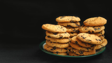 Closeup of homemade Chocolate Chip Drop Biscuits / Cookies isolated on black with negative space