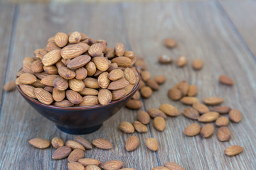 Macadamia nut on wood background.