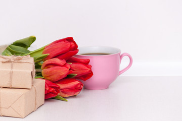 Tulips, presents, cup for mother, wife, daughter, girl with love. Happy birthday, Mother's day. Woman's day. Copy spase.