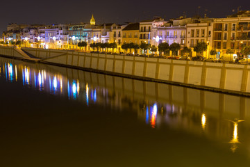 Sevilla, Andalusia, Spain - 04/01/2019 the vibrant calle Betis (English translation: Betis Street) in Seville during blue hour. The street is located in Triana and on the bank of Guadalquivir river