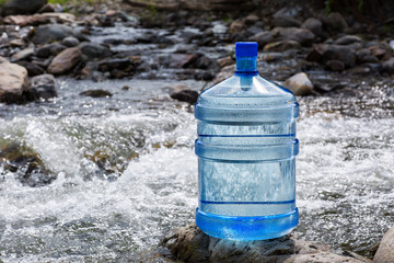 Water big bottle on mountains and rivers background - 249863382