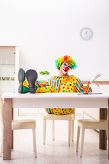 Male clown preparing for perfomance at home 