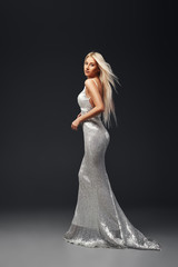 Fototapeta premium Fashion Model Beauty Dress, Waving Silver Cloth Gown, Woman in White Fluttering Clothes Fabric, over Night Background 