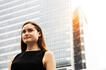 Business woman portrait and building background.