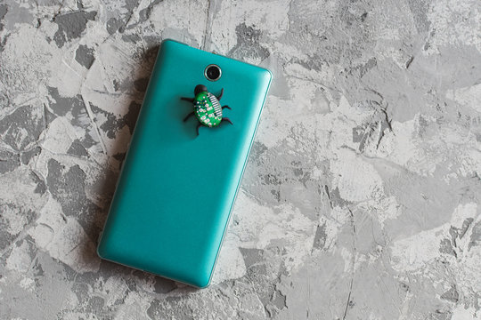 concept of wiretapping of smartphones. bug near the camera on the smartphone - Powered by Adobe