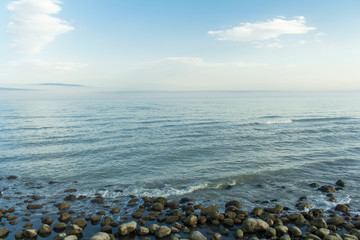 Waves hitting the shore. stones on sea shore