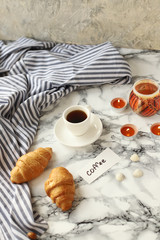 a Cup of coffee and croissants with the words Good morning 