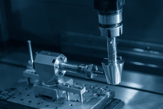 The EDM machine making the spiral groove on the cone shape. The rotary EDM process with special part.