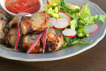 Barbecue meat. Grilled pork skewers with salad on plate.