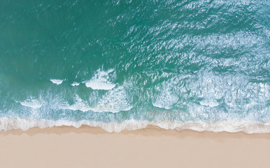 Top view of beautiful sand beach with turquoise sea water,Wave propagation,aerial view from drone camera / Summer concept.