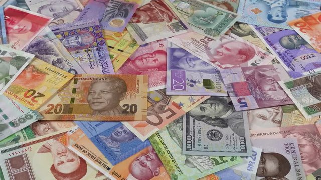Variety of world currencies notes slow rotating. World money, economy. Low angle. 4K stock video footage