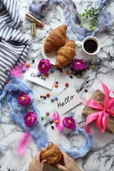a Cup of coffee and croissants with the words Good morning and Hello