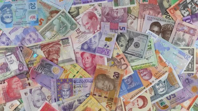 Heap of world currencies notes slow rotating. World money, economy. 4K stock video footage