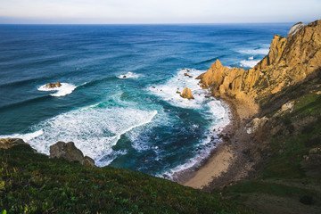 Fototapeta na wymiar Beautiful ocean view of the Praia de Ursa, a wild place near touristic Cabo da Roca lighthouse, Portugal