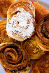 Fresh bakery on white plate, overhead view. Flat lay, from above, top view. Close-up.