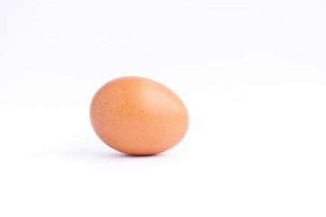 Brown chicken egg isolated on a light background lies
