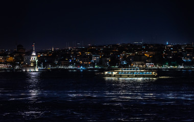 View of an Asian part of Istanbul, Maiden tower and the walking ship, on night fires is visible.