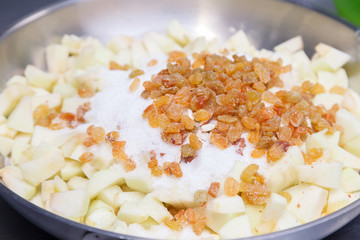 Fresh cut apple, raisins, sprinkled with sugar for cooking apple charlotte pie. Concept confectionery, pastry shop, baking, cake, sweet dessert