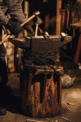 blacksmith splits firewood for kindling the furnace.
