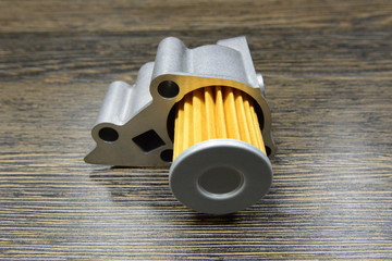 CVT transmission filter on wooden background