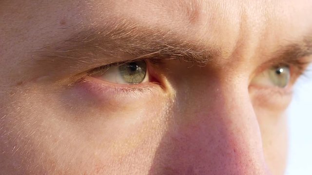 Runner's eyes. Man looks at the dawn and starts to run. Close up