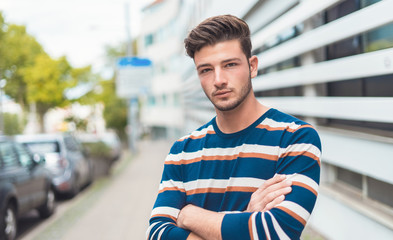 Half length portrait of a beautiful young man in the city © Alen-D