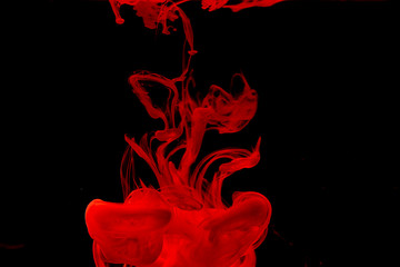 Color paint drops in water. Ink swirling underwater.