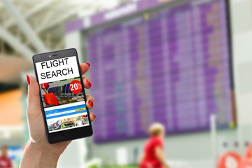 E-ticket on smartphone screen with timetable in the blurred background. Buying online ticket from internet. Universal public transportation terminal. Bus, train, metro, subway or underground station