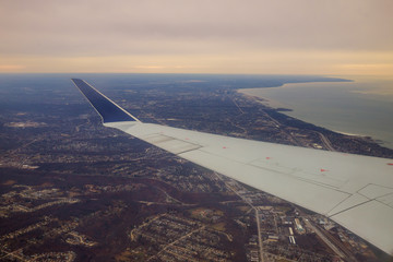 Winglet in graduated dark blue sky with a view of big city below in Cleveland Ohio.