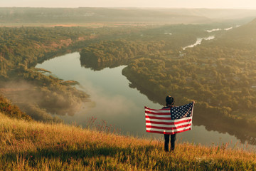 Traveler with flag in picturesque nature