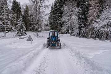 old blue fordson dexta tractor plowing snow