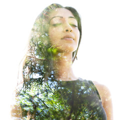 Double exposure close up of a young natural beauty with closed eyes combined with a healthy tree whose branches blend seamlessly into her healthy being
