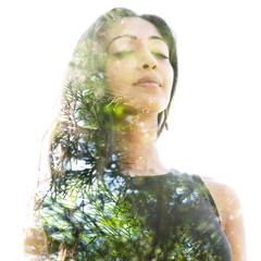 Double exposure close up of a young natural beauty with closed eyes combined with a healthy tree...