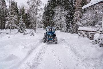 old blue fordson dexta tractor plowing snow