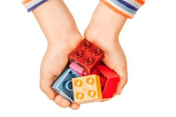 Children's hands hold parts of blocks