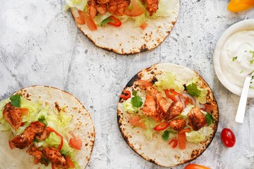Homemade soft Grilled salmon fish Tacos drizzled with sour cream, selective focus