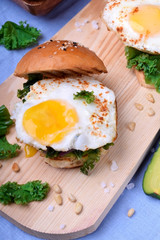 Sandwich with fried egg and salad with kale