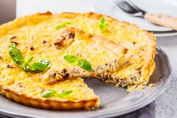 Homemade tuna pie with tomatoes and basil.