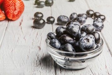 Healthy fruit, strawberry, blueberry, sweet cherry on wooden whi