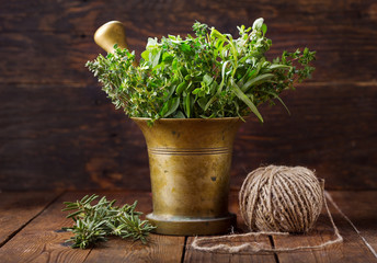 fresh green herbs in a mortar