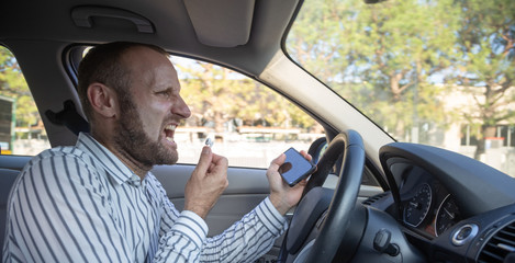 Dangerous man driving with his mobile phone