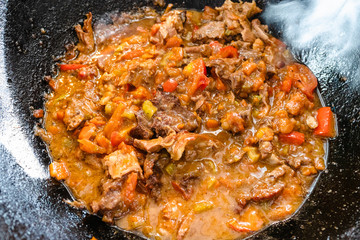 pottage from lamb and vegetables in iron cauldron