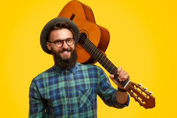 Smiling guy with acoustic guitar